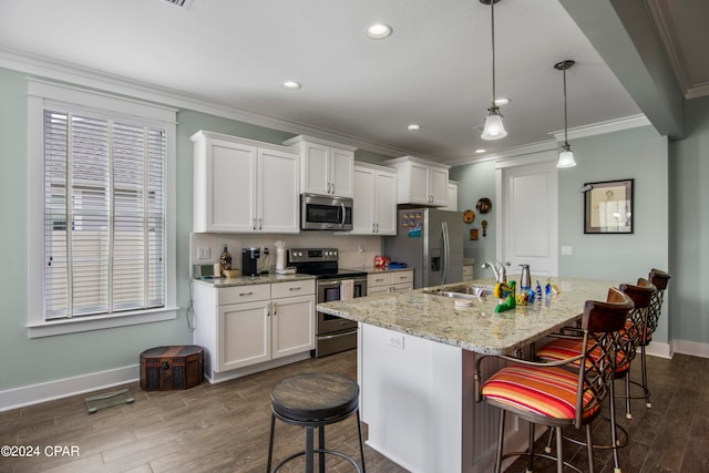 kitchen with white cabinetry, stainless steel appliances, a center island with sink, a breakfast bar area, and pendant lighting