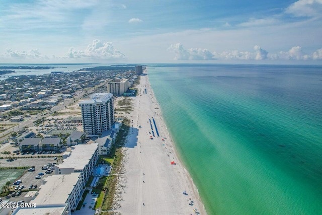 birds eye view of property with a water view and a beach view