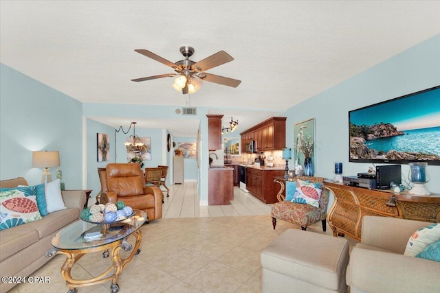 tiled living room featuring a textured ceiling, ceiling fan with notable chandelier, and sink