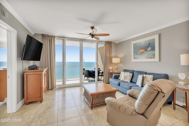 living room featuring a ceiling fan, expansive windows, crown molding, light tile patterned floors, and baseboards