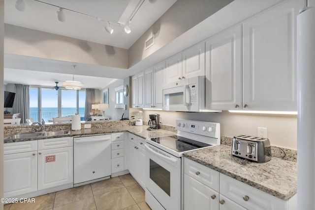 kitchen with visible vents, a ceiling fan, a sink, white appliances, and white cabinets