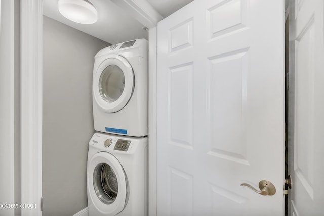 laundry room featuring stacked washer and dryer and laundry area