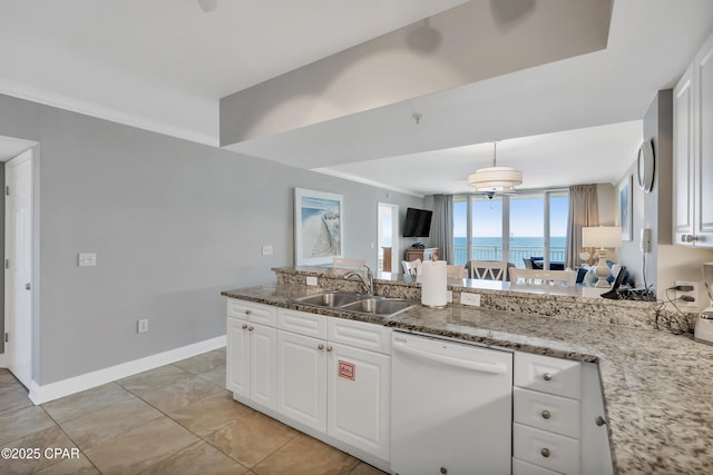 kitchen with a sink, light stone countertops, dishwasher, and white cabinets