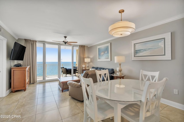 dining area with a wall of windows, crown molding, light tile patterned flooring, and baseboards