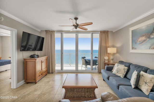 living room featuring light tile patterned floors, baseboards, ceiling fan, expansive windows, and crown molding