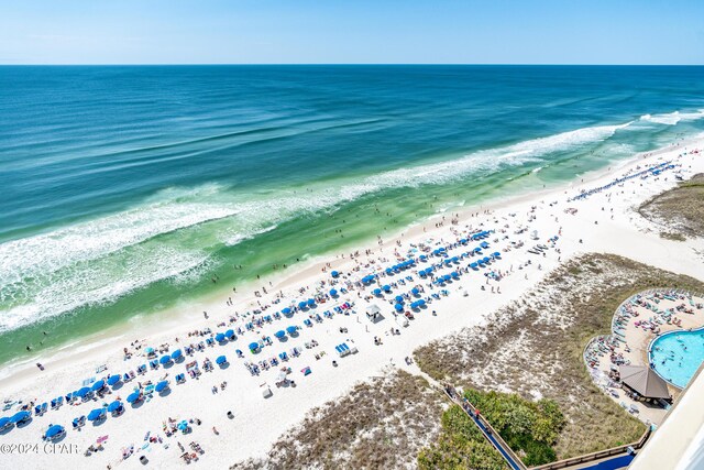 birds eye view of property featuring a water view and a beach view