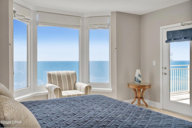 tiled bedroom with access to exterior and a water view