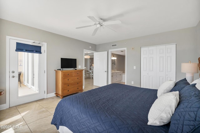 bedroom featuring light tile patterned floors, baseboards, visible vents, ensuite bath, and ceiling fan