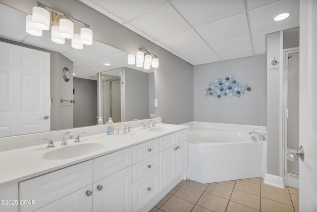 full bath featuring a sink, a shower stall, a bath, and tile patterned floors