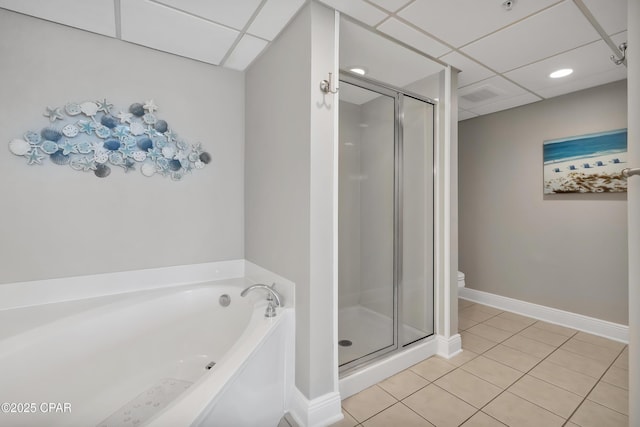 bathroom with a shower stall, a garden tub, baseboards, and tile patterned floors