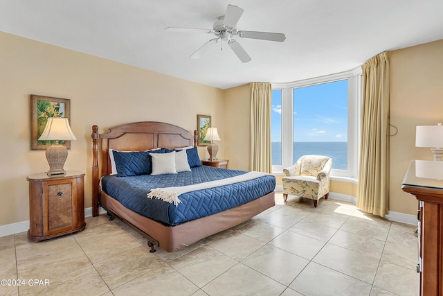 bedroom with light tile patterned floors, a ceiling fan, and baseboards