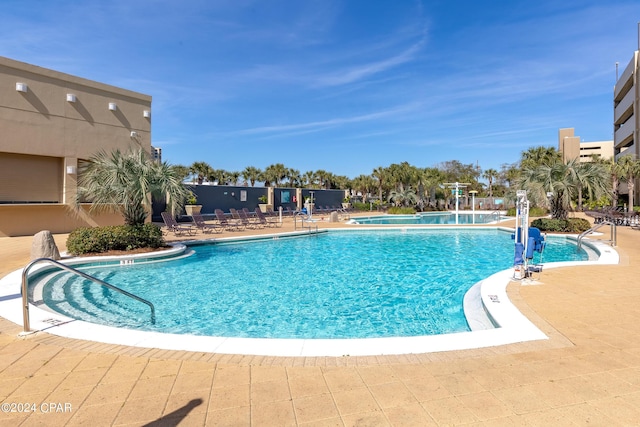 community pool with a patio area