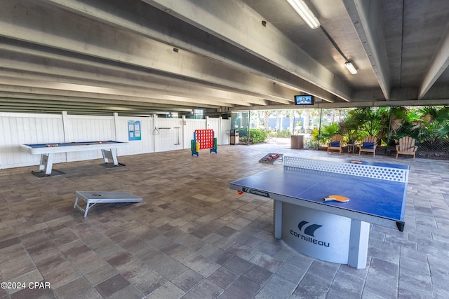 exterior space featuring beam ceiling and pool table