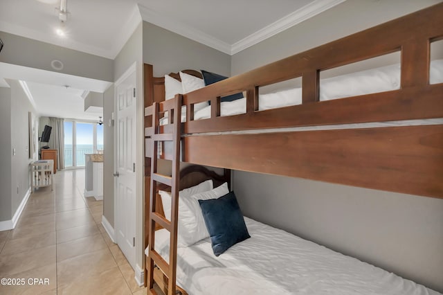 tiled bedroom featuring baseboards and ornamental molding