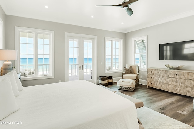 bedroom featuring french doors, access to exterior, ceiling fan, dark wood-type flooring, and a water view