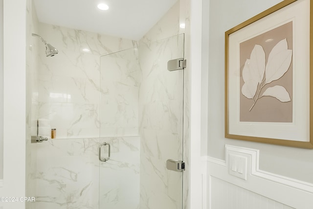 bathroom featuring a shower with shower door