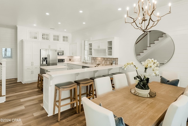 dining room with plenty of natural light, an inviting chandelier, and hardwood / wood-style floors