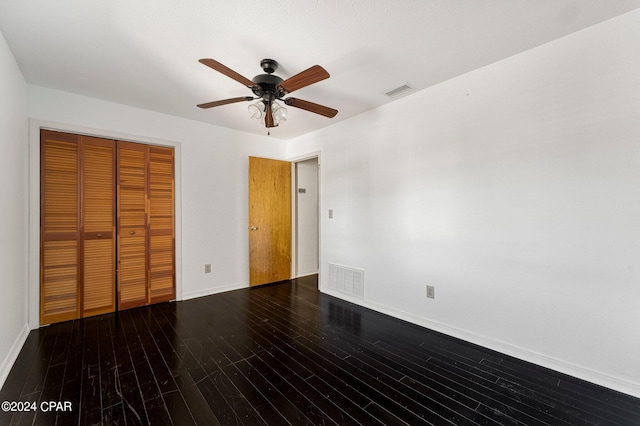 unfurnished bedroom with a closet, wood-type flooring, and ceiling fan