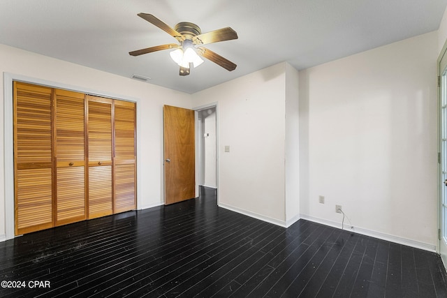 unfurnished bedroom featuring a closet, dark hardwood / wood-style floors, and ceiling fan