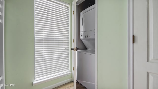 washroom with stacked washer / dryer and laundry area