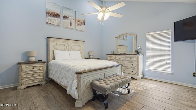 bedroom with a ceiling fan, baseboards, and wood finished floors