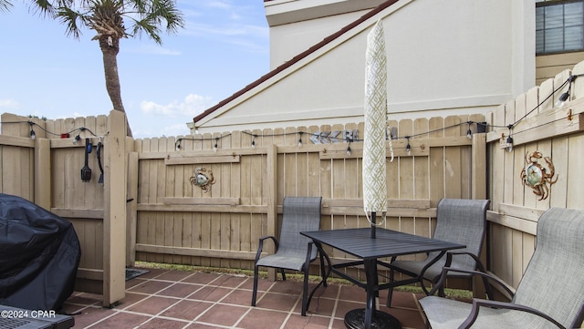 view of patio with grilling area and fence