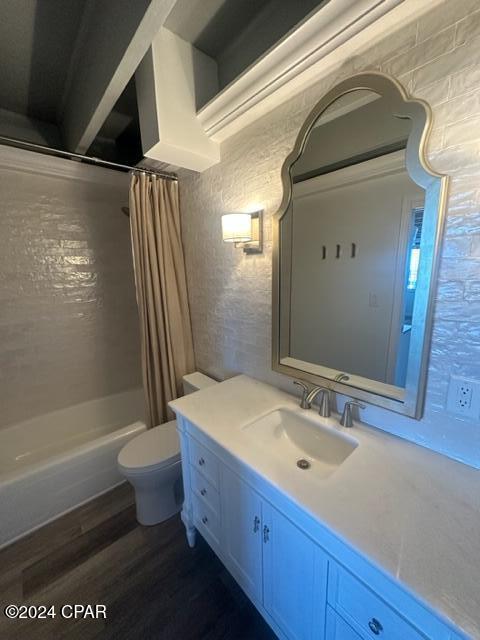 full bathroom with hardwood / wood-style flooring, vanity, toilet, and shower / bathtub combination with curtain