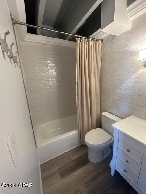 full bathroom featuring vanity, hardwood / wood-style flooring, toilet, and shower / bath combo with shower curtain