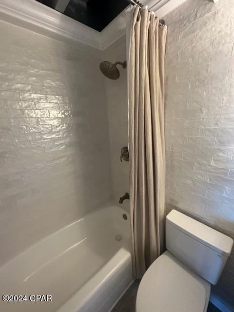 bathroom with toilet and shower / tub combo