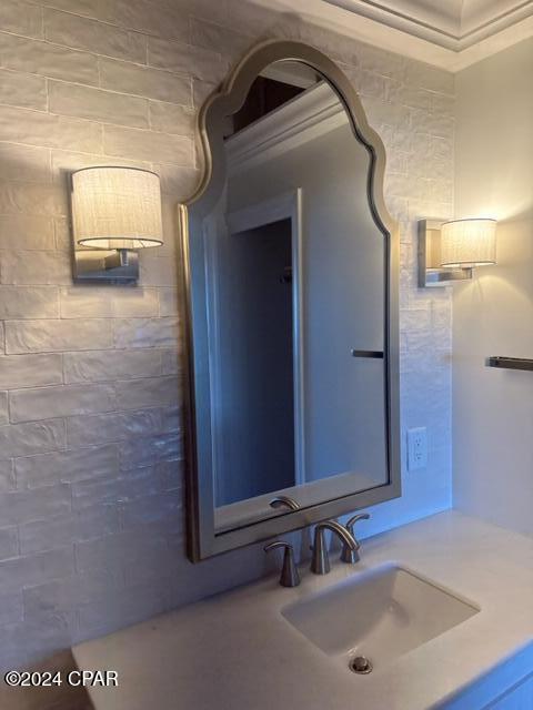 bathroom featuring sink and ornamental molding