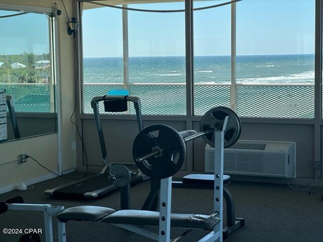 workout area featuring a water view