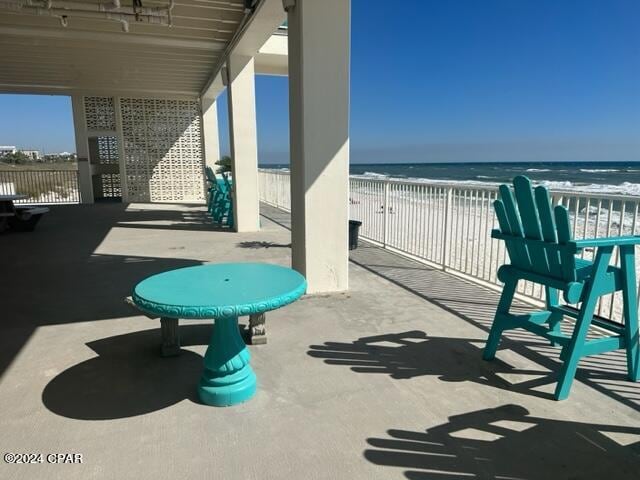 view of patio featuring a water view and a view of the beach