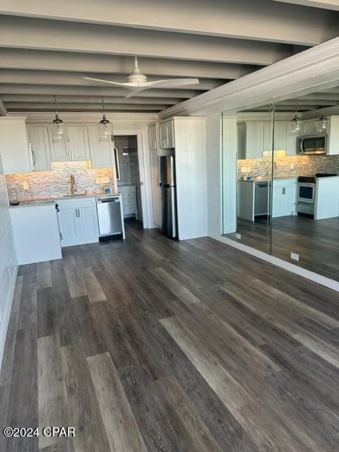 kitchen with pendant lighting, dark hardwood / wood-style floors, tasteful backsplash, beamed ceiling, and white cabinetry