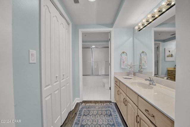 bathroom with vanity, tile floors, and toilet