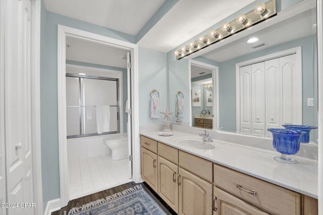 bathroom featuring oversized vanity, tile floors, and toilet