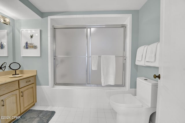 full bathroom featuring shower / bath combination with glass door, vanity, tile floors, and toilet