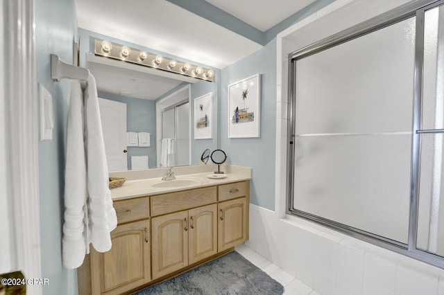 bathroom featuring walk in shower, tile flooring, and vanity