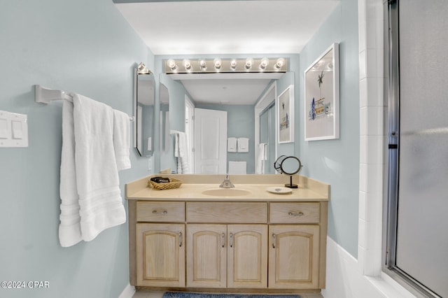 bathroom with an enclosed shower and vanity