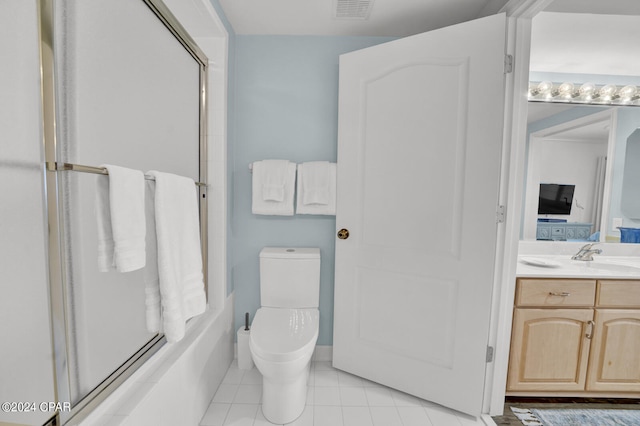 bathroom featuring tile floors, oversized vanity, and toilet