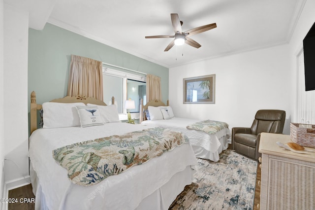 bedroom featuring ornamental molding, dark hardwood / wood-style flooring, and ceiling fan