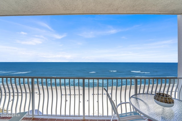 balcony with a beach view and a water view