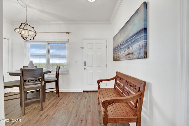 sitting room with light hardwood / wood-style floors, crown molding, and a chandelier