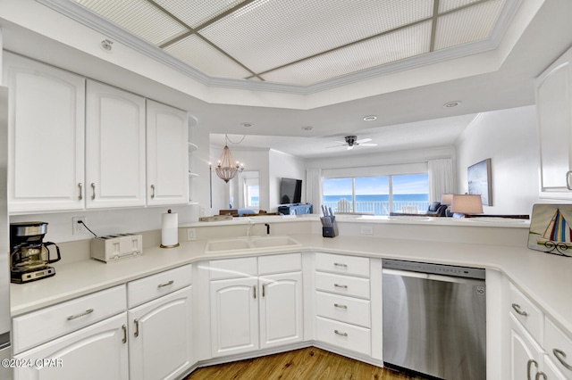 kitchen featuring stainless steel dishwasher, sink, light hardwood / wood-style flooring, and white cabinetry