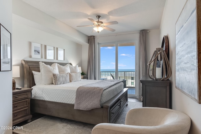 bedroom with a water view, ceiling fan, and access to exterior