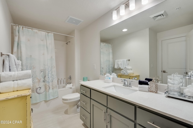 full bathroom featuring vanity, toilet, and shower / tub combo