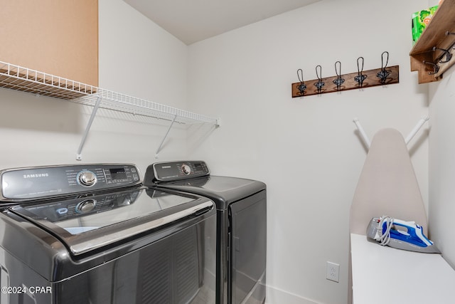 clothes washing area with separate washer and dryer