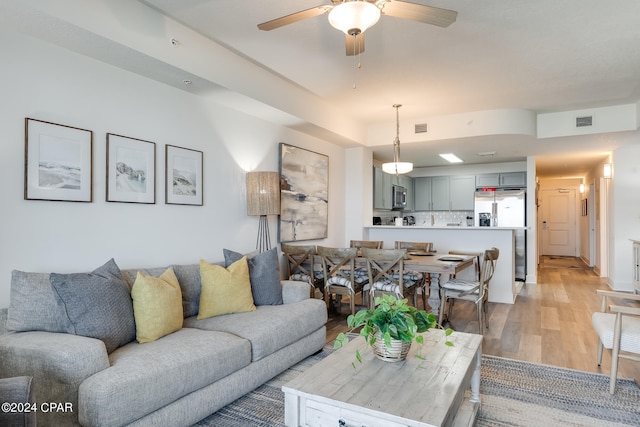 living room featuring light hardwood / wood-style flooring and ceiling fan