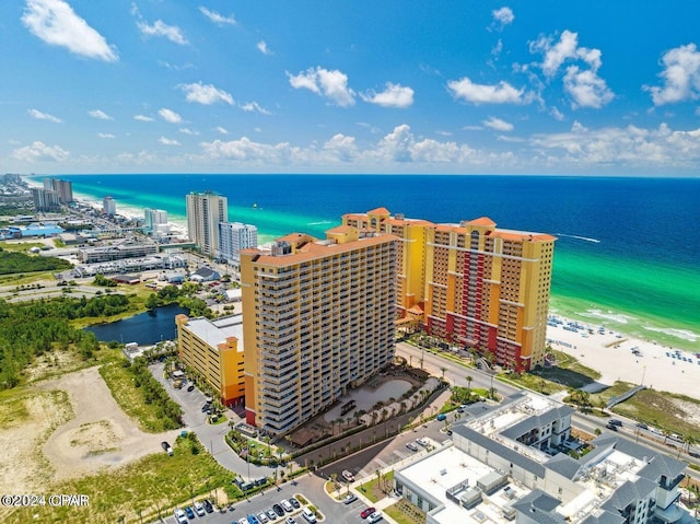 bird's eye view featuring a water view and a beach view