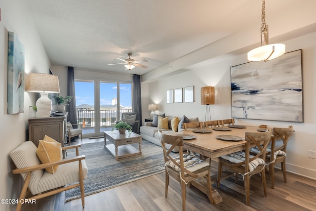 dining space with ceiling fan and light hardwood / wood-style floors