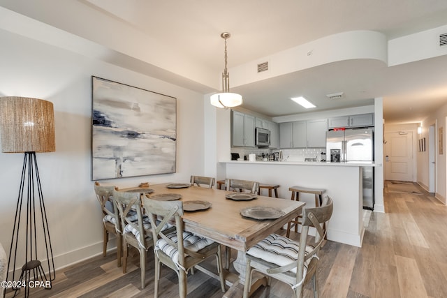 dining area featuring light wood-type flooring